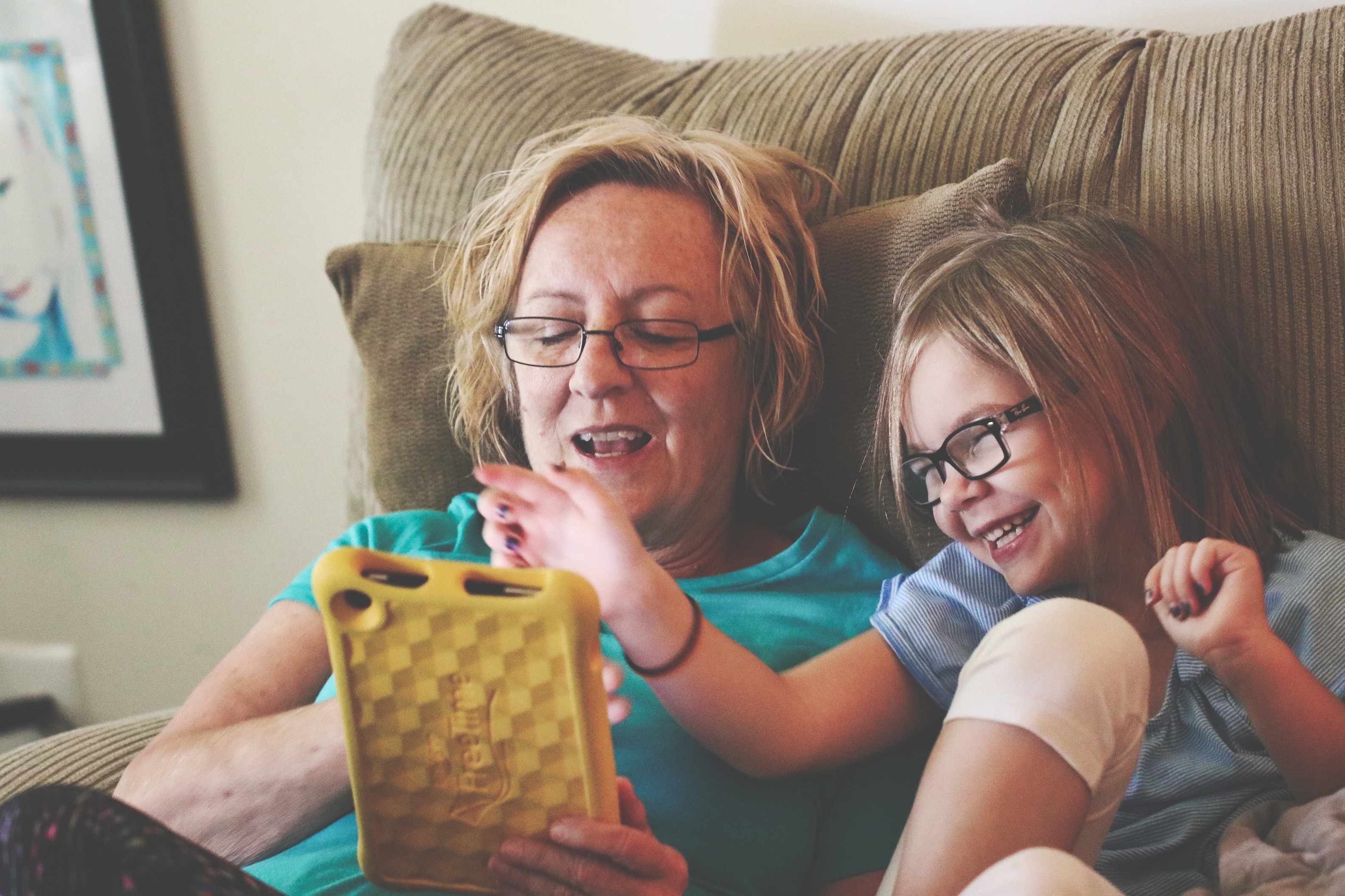 grandmother and grandaugher interacting with tablet device